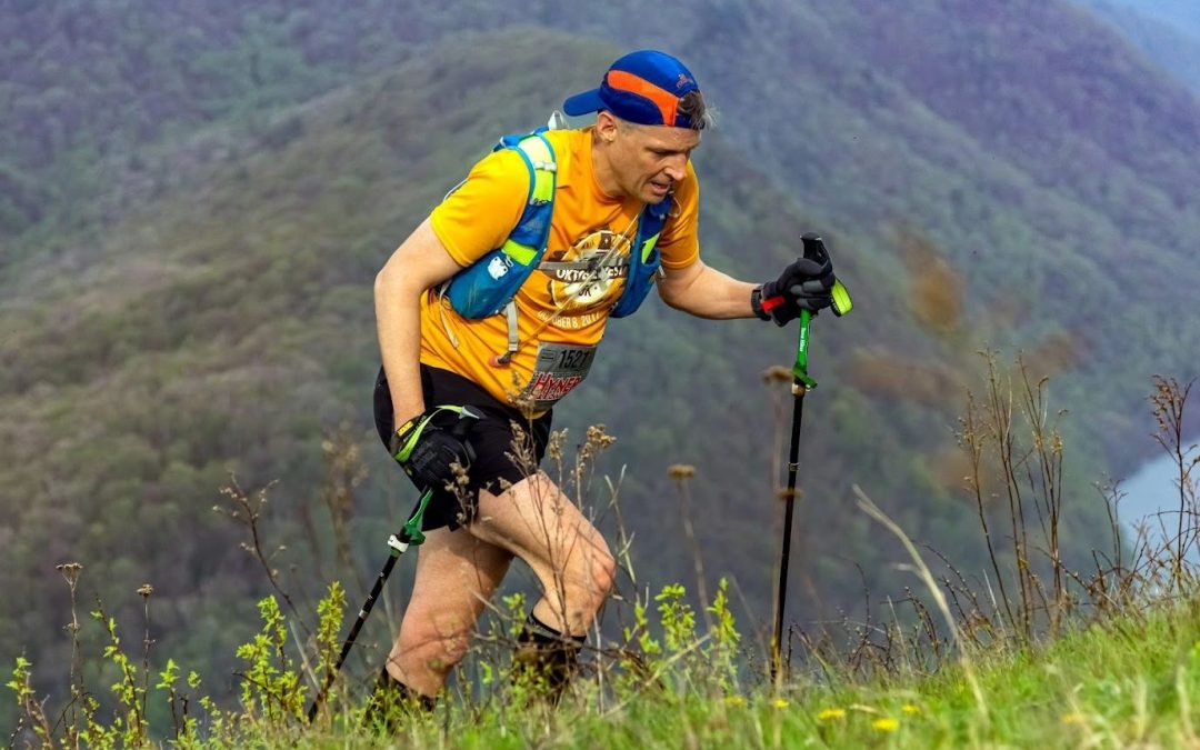 Hyner Trail Challenge runner wearing blue and orange Racetrackers Hyner Hat.