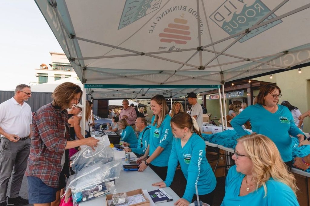 Volunteers help with packet pick up of race shirts, bibs, and course info at the Wild Rogue Relay in southern Oregon.