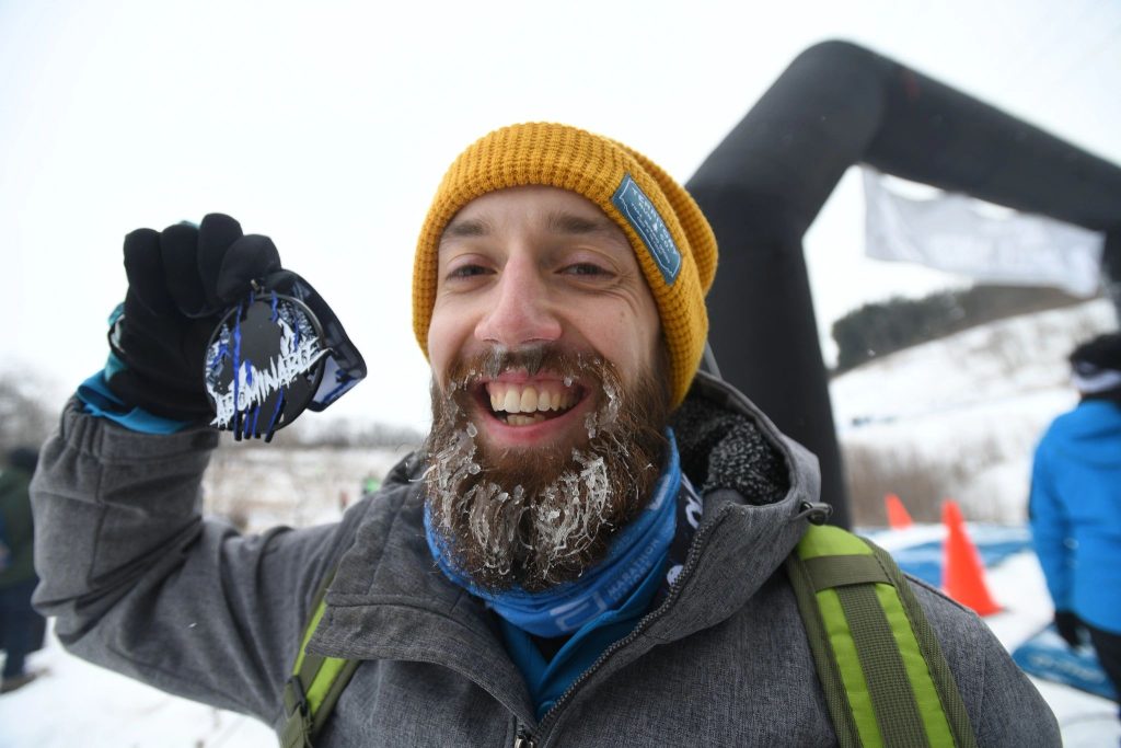 Happy, but cold, finisher with his race medal at the Abominable Snow Race in Wisconsin.