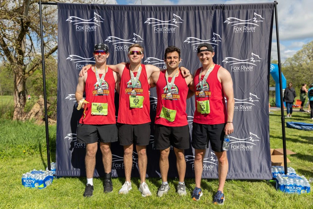 Finishers in Branded Race Shirts With Their Finisher Medals at the Fox River Trail Runner's Great Western Half and 10K