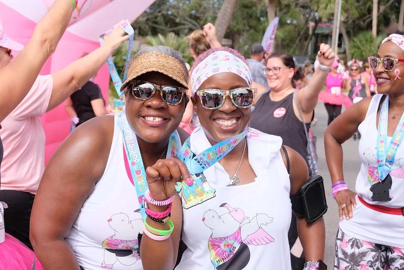 Runners celebrate their finishes at the race pavilion of the Pledge the Pink Race.