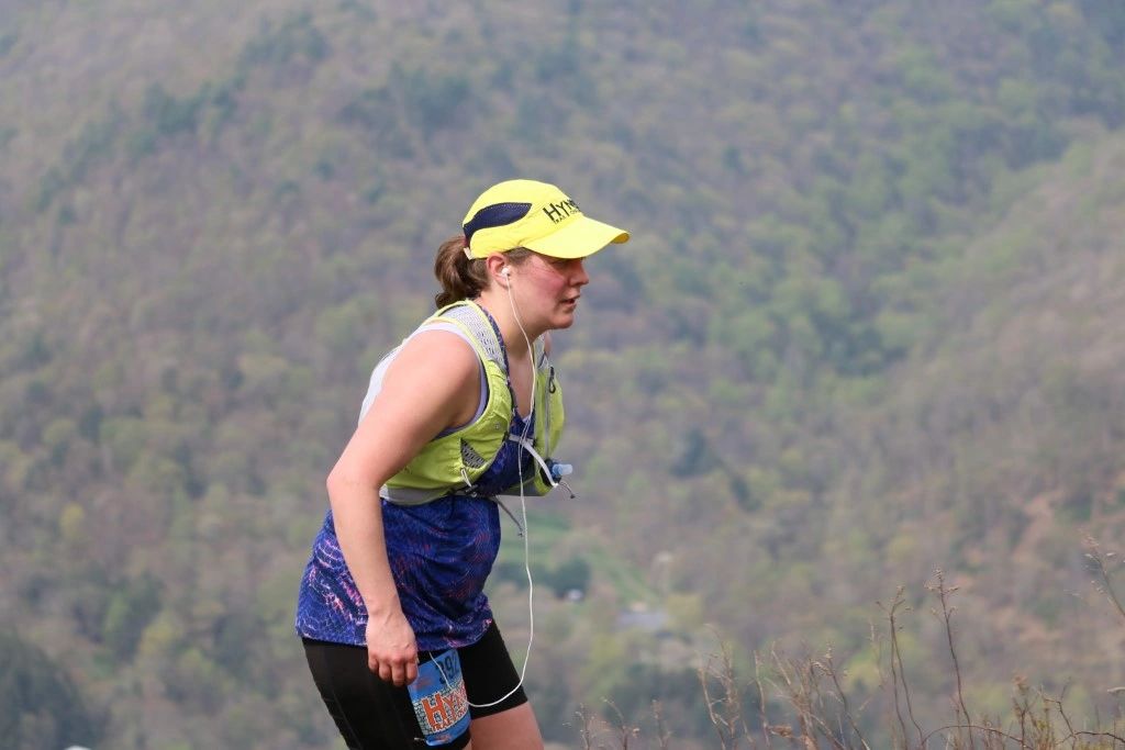 Hyner Trail Challenge Runner in yellow and navy Racetrackers Hyner Hat.